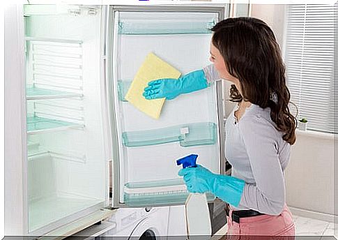 Woman cleaning the refrigerator