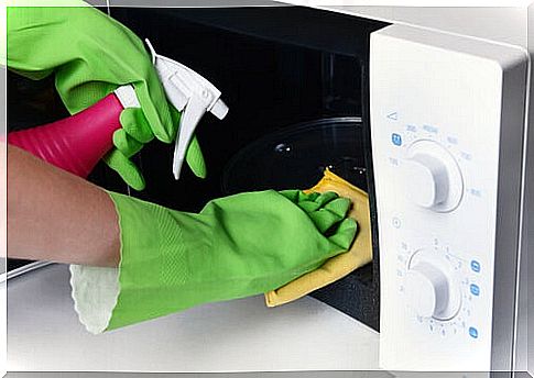 Woman cleaning the microwave