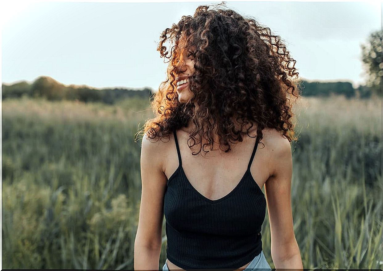 Woman smiling in a meadow in summer.