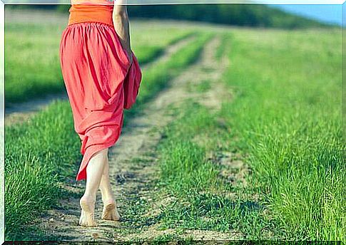 Woman-in-red-skirt-walking-along-a-path