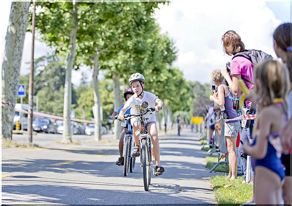 Boy winning a bicycle race to achieve his goals.