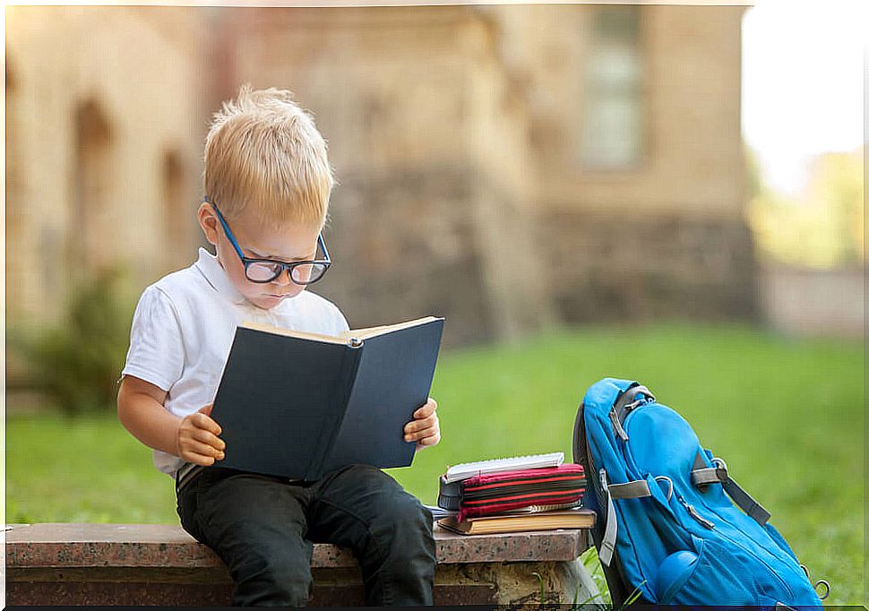 Boy with a book reading.