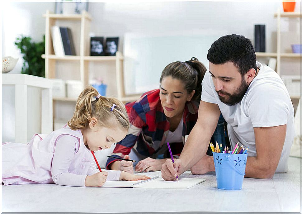 Parents with their daughter doing homework.