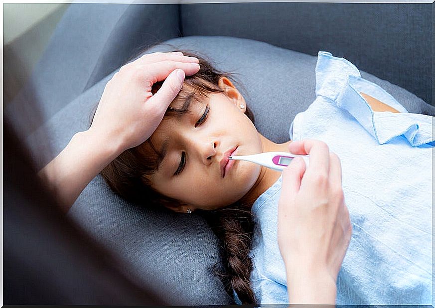 Girl with fever and thermometer