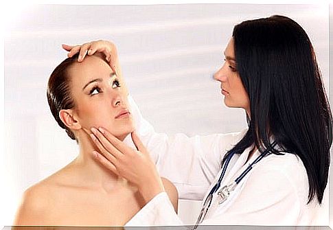 Female doctor observing the skin of a patient