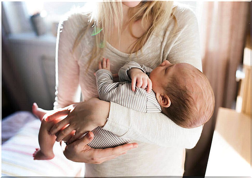 Baby in his mother's arms.