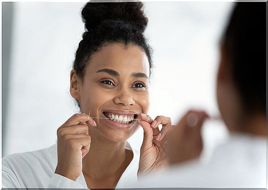 Woman using dental floss