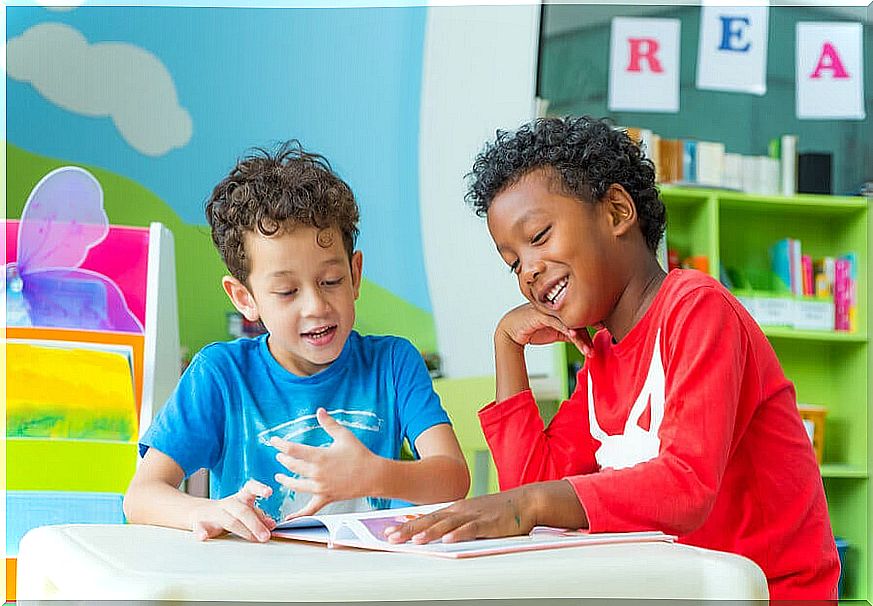 Children chatting about a book.